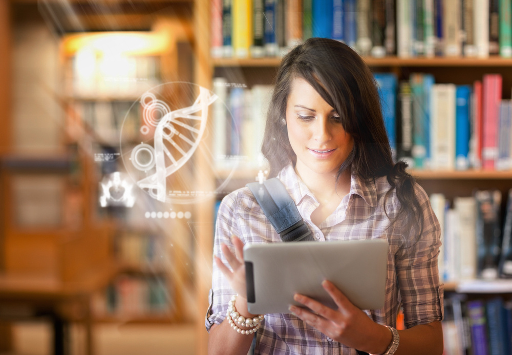 Pretty student using futuristic interface to learn about science from digital tablet standing in college library